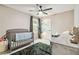 Cozy Bedroom with a gray crib, modern ceiling fan, and a plush green rug at 10190 Natural Anchor St, Las Vegas, NV 89166