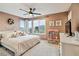 Bedroom featuring a large window, dresser, ceiling fan, and stylish furnishings at 10190 Natural Anchor St, Las Vegas, NV 89166