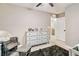 Bedroom featuring a dresser, rocker, and view of the ensuite bathroom at 10190 Natural Anchor St, Las Vegas, NV 89166