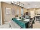 Dining area featuring modern light fixtures and a large table with seating for six, adjacent to the kitchen at 10190 Natural Anchor St, Las Vegas, NV 89166