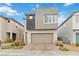 Contemporary two-story home with a neutral color scheme, two-car garage, and a landscaped front yard at 10190 Natural Anchor St, Las Vegas, NV 89166