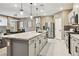 Open-concept kitchen with granite countertops, stainless steel appliances, and stylish pendant lighting over a large island at 10190 Natural Anchor St, Las Vegas, NV 89166