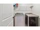 Convenient laundry room equipped with modern washer and dryer, and useful shelving at 10190 Natural Anchor St, Las Vegas, NV 89166