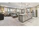 Spacious living area featuring kitchen island, stainless appliances, dining space, and comfortable living room at 10190 Natural Anchor St, Las Vegas, NV 89166