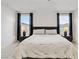 Inviting main bedroom with plush bedding, stylish bedside lamps, and large windows at 10190 Natural Anchor St, Las Vegas, NV 89166