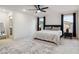 Modern main bedroom with gray bedding, contemporary lamps, and an ensuite bathroom view at 10190 Natural Anchor St, Las Vegas, NV 89166