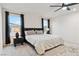 Bright main bedroom with a modern ceiling fan, black accents, and cozy neutral bedding at 10190 Natural Anchor St, Las Vegas, NV 89166