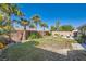 Lush backyard with green grass and tropical landscaping at 10212 Donald Weese Ct, Las Vegas, NV 89129