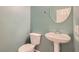 Neat bathroom with pedestal sink and toilet, complemented by light blue paint at 10212 Donald Weese Ct, Las Vegas, NV 89129