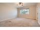 Bright bedroom with large window, plush carpet, and neutral color palette for relaxation at 10212 Donald Weese Ct, Las Vegas, NV 89129
