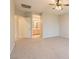 Carpeted bedroom featuring a view of the attached bathroom with wooden cabinets and a tile floor at 10212 Donald Weese Ct, Las Vegas, NV 89129