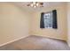 Neutral bedroom features a ceiling fan and a large window at 10212 Donald Weese Ct, Las Vegas, NV 89129