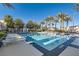 Beautiful community pool with lounge chairs surrounded by palm trees at 10212 Donald Weese Ct, Las Vegas, NV 89129