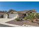Attractive single-story home with a three-car garage, desert landscaping, and a well-kept exterior at 10212 Donald Weese Ct, Las Vegas, NV 89129