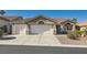 Charming single-story home featuring a three-car garage, well-maintained landscaping, and a tile roof at 10212 Donald Weese Ct, Las Vegas, NV 89129