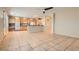 Open kitchen featuring wood cabinetry, tile flooring, and bar top, perfect for entertaining at 10212 Donald Weese Ct, Las Vegas, NV 89129