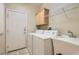 Functional laundry area with a sink, washer, dryer and storage at 10212 Donald Weese Ct, Las Vegas, NV 89129