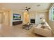 Comfortable living room with fireplace, ceiling fan, and wall mounted tv for a cozy and entertaining atmosphere at 10212 Donald Weese Ct, Las Vegas, NV 89129