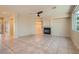 Spacious living room features tile flooring, fireplace, and a ceiling fan, awaiting personalized touches at 10212 Donald Weese Ct, Las Vegas, NV 89129