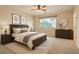 Charming bedroom with neutral decor, large window, and coordinated furnishings, ready for relaxation at 10212 Donald Weese Ct, Las Vegas, NV 89129