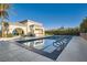 Community pool featuring clear blue water and a covered lounge area at 10212 Donald Weese Ct, Las Vegas, NV 89129
