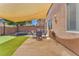 Backyard featuring a patio area with outdoor seating, artificial grass, and a trampoline at 10353 Settlers Run Ave, Las Vegas, NV 89166