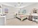 Comfortable bedroom with neutral tones, plush carpet, and a ceiling fan at 10353 Settlers Run Ave, Las Vegas, NV 89166