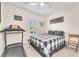 Cozy bedroom with a ceiling fan, shuttered windows, and a comfortable bed with stylish decor at 10353 Settlers Run Ave, Las Vegas, NV 89166