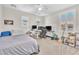 Spacious bedroom with ample natural light, plush carpet, and a ceiling fan at 10353 Settlers Run Ave, Las Vegas, NV 89166