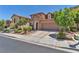 Inviting two-story home with a stone accent and two-car garage surrounded by mature trees in a friendly neighborhood at 10353 Settlers Run Ave, Las Vegas, NV 89166