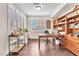 Spacious home office with a large desk, ample storage, and bright natural light from the window at 10353 Settlers Run Ave, Las Vegas, NV 89166