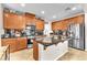 Well-lit kitchen with stainless steel appliances, granite countertops, and ample cabinet space at 10353 Settlers Run Ave, Las Vegas, NV 89166