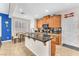 Bright kitchen featuring a granite island, stainless steel appliances, and a door leading to the backyard at 10353 Settlers Run Ave, Las Vegas, NV 89166