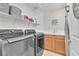 Efficient laundry room equipped with modern washer and dryer, storage, and a sink at 10353 Settlers Run Ave, Las Vegas, NV 89166