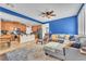 Open-concept living room and kitchen with modern furnishings, comfortable seating, and stylish decor at 10353 Settlers Run Ave, Las Vegas, NV 89166