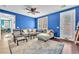 Inviting living room showcasing a comfortable gray sectional sofa, stylish decor, and backyard access at 10353 Settlers Run Ave, Las Vegas, NV 89166