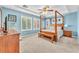 Main bedroom boasts a four-poster bed, plantation shutters, and blue accent walls at 10353 Settlers Run Ave, Las Vegas, NV 89166