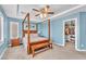 Main bedroom boasts a four-poster bed, plantation shutters, and a walk-in closet at 10353 Settlers Run Ave, Las Vegas, NV 89166
