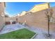The backyard patio includes space for grilling, a small patch of grass, and rock landscaping at 10940 Oregano Ave, Las Vegas, NV 89166