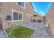A backyard with a built-in grill, artificial grass and stone landscaping at 10940 Oregano Ave, Las Vegas, NV 89166