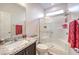 Bathroom features a granite countertop, single sink, framed mirror, toilet, and tile surround shower with glass doors at 10940 Oregano Ave, Las Vegas, NV 89166