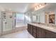 Bathroom featuring double vanity, bathtub, and shower with glass door at 10940 Oregano Ave, Las Vegas, NV 89166