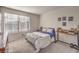 Comfortable bedroom with a large window for natural light and space for a desk at 10940 Oregano Ave, Las Vegas, NV 89166