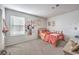Bedroom with carpet, a window, and a small bed, offering a cozy and comfortable space at 10940 Oregano Ave, Las Vegas, NV 89166