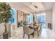 Bright dining room featuring modern lighting, large mirrors, and a dining table set for six at 10940 Oregano Ave, Las Vegas, NV 89166
