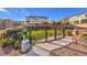 Fenced dog park area with green grass, waste station, and bench seating for community enjoyment at 10940 Oregano Ave, Las Vegas, NV 89166