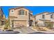Inviting home exterior with well-maintained landscaping, two-car garage and a welcoming front entrance at 10940 Oregano Ave, Las Vegas, NV 89166