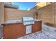 Close up of a built-in barbecue grill on a stone patio in the backyard at 10940 Oregano Ave, Las Vegas, NV 89166