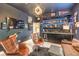 Cozy living room with a modern wet bar, comfortable seating, and a flat screen television at 10940 Oregano Ave, Las Vegas, NV 89166