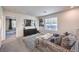 Upstairs living room includes carpet, a TV, a sofa and a window to provide natural light at 10940 Oregano Ave, Las Vegas, NV 89166